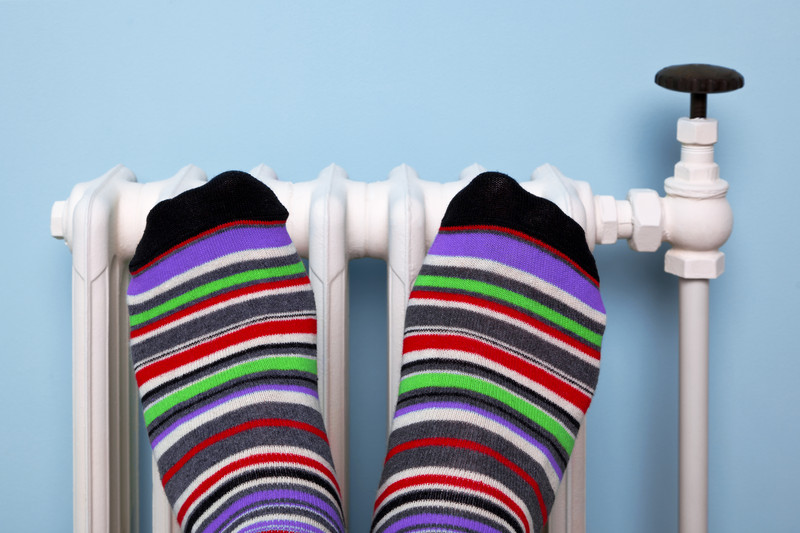 Feet keeping warm on a radiator